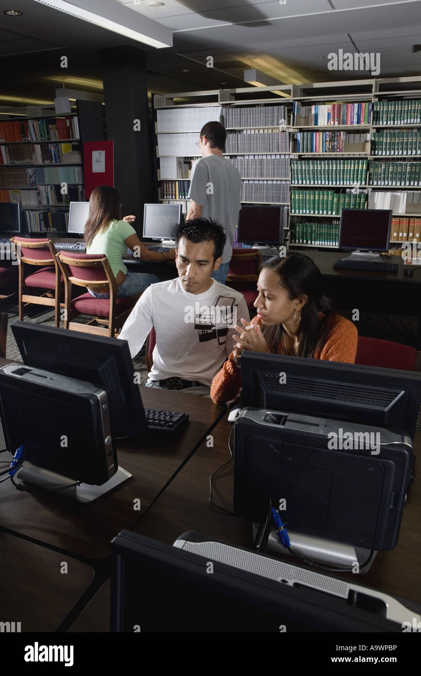 College students using computers in the library Stock Photo - Alamy