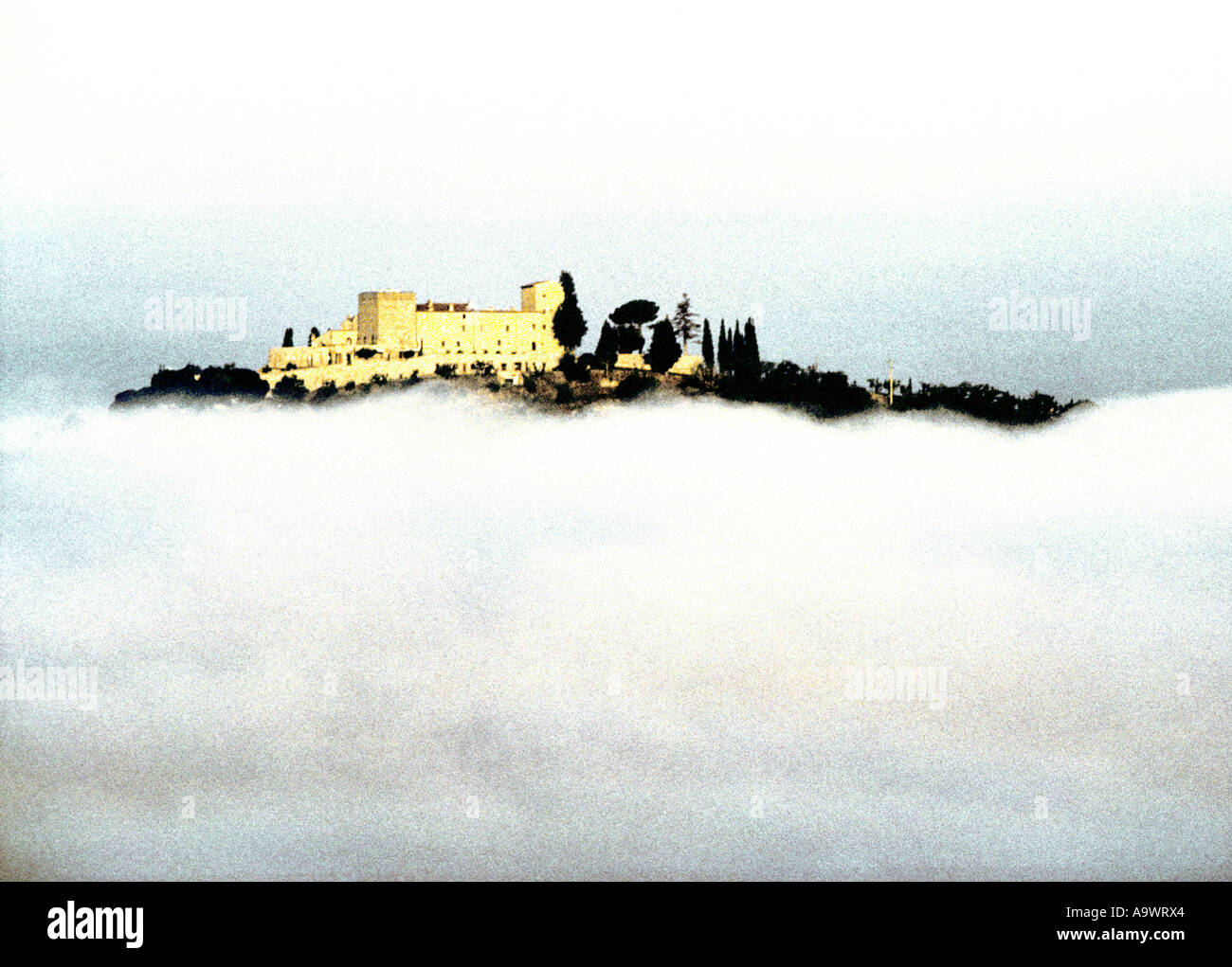 Italy, Tuscany, Tuscana, Castle emerging from fog, val D'orcia Castiglione di castle Orcia valley Stock Photo