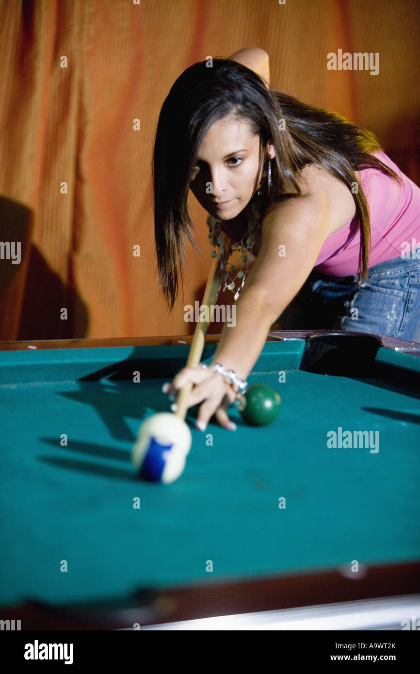 Young woman shooting pool Stock Photo