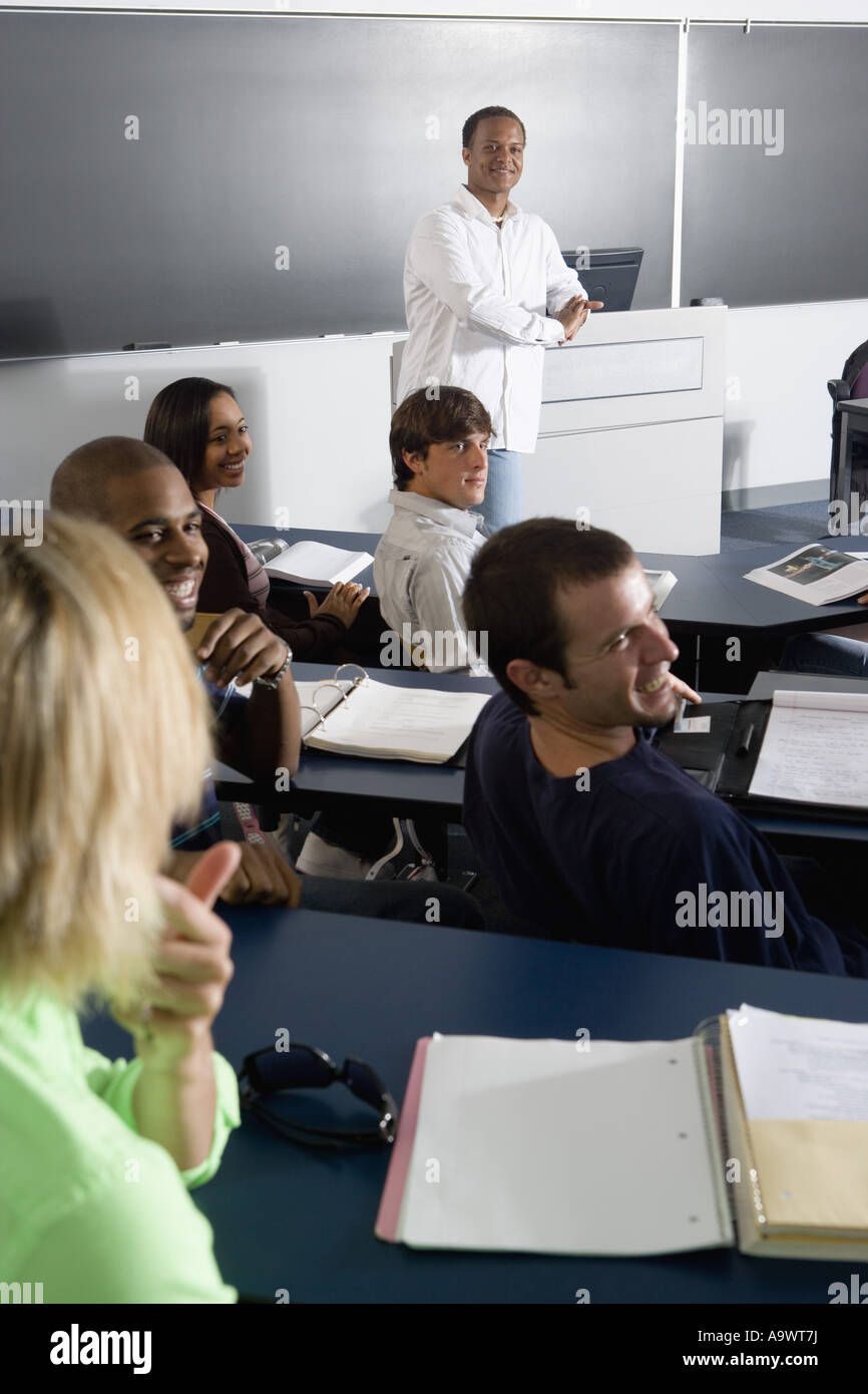 Teacher teaching students in the classroom Stock Photo - Alamy