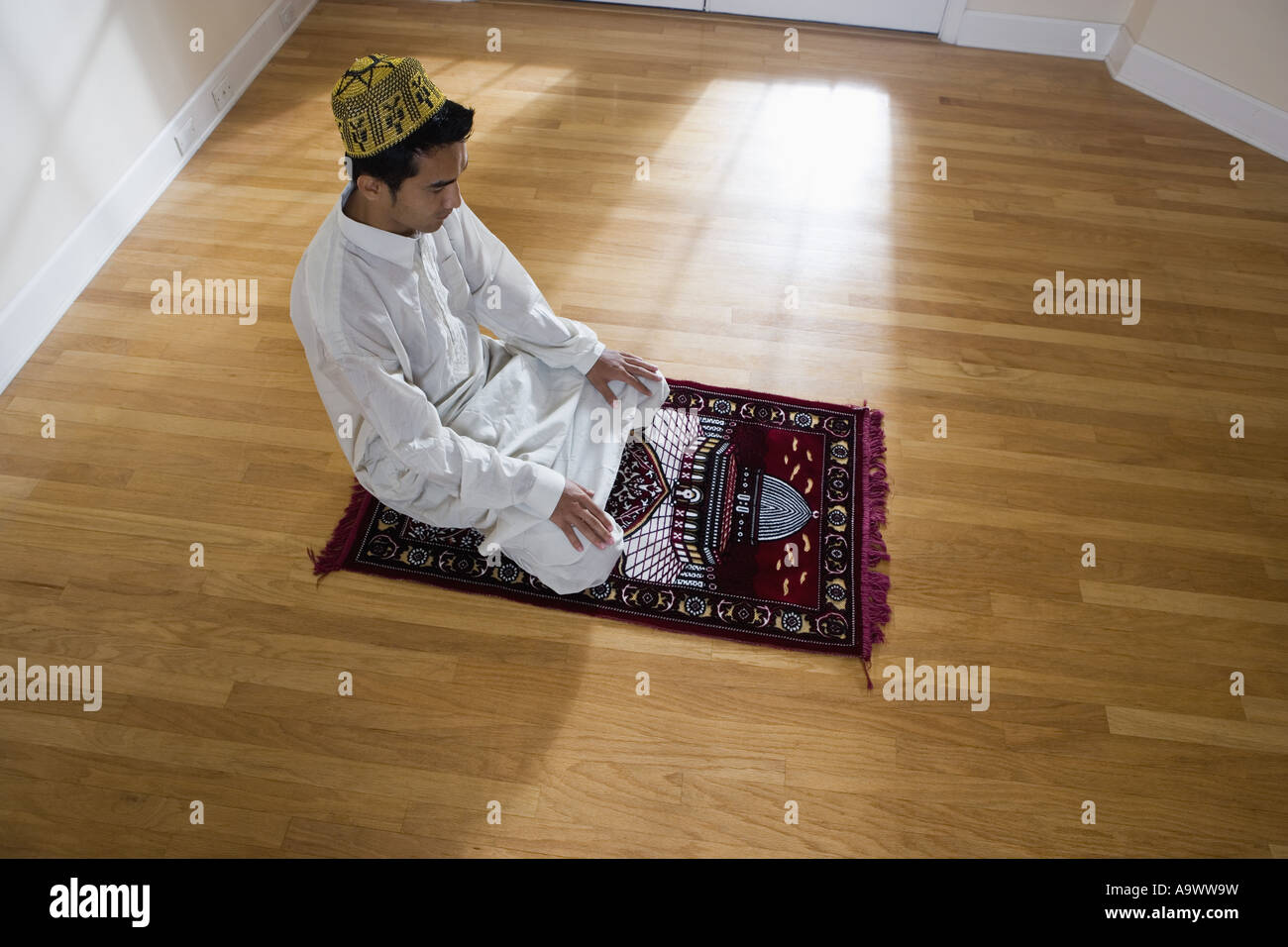 Young man praying on knees hi-res stock photography and images - Alamy