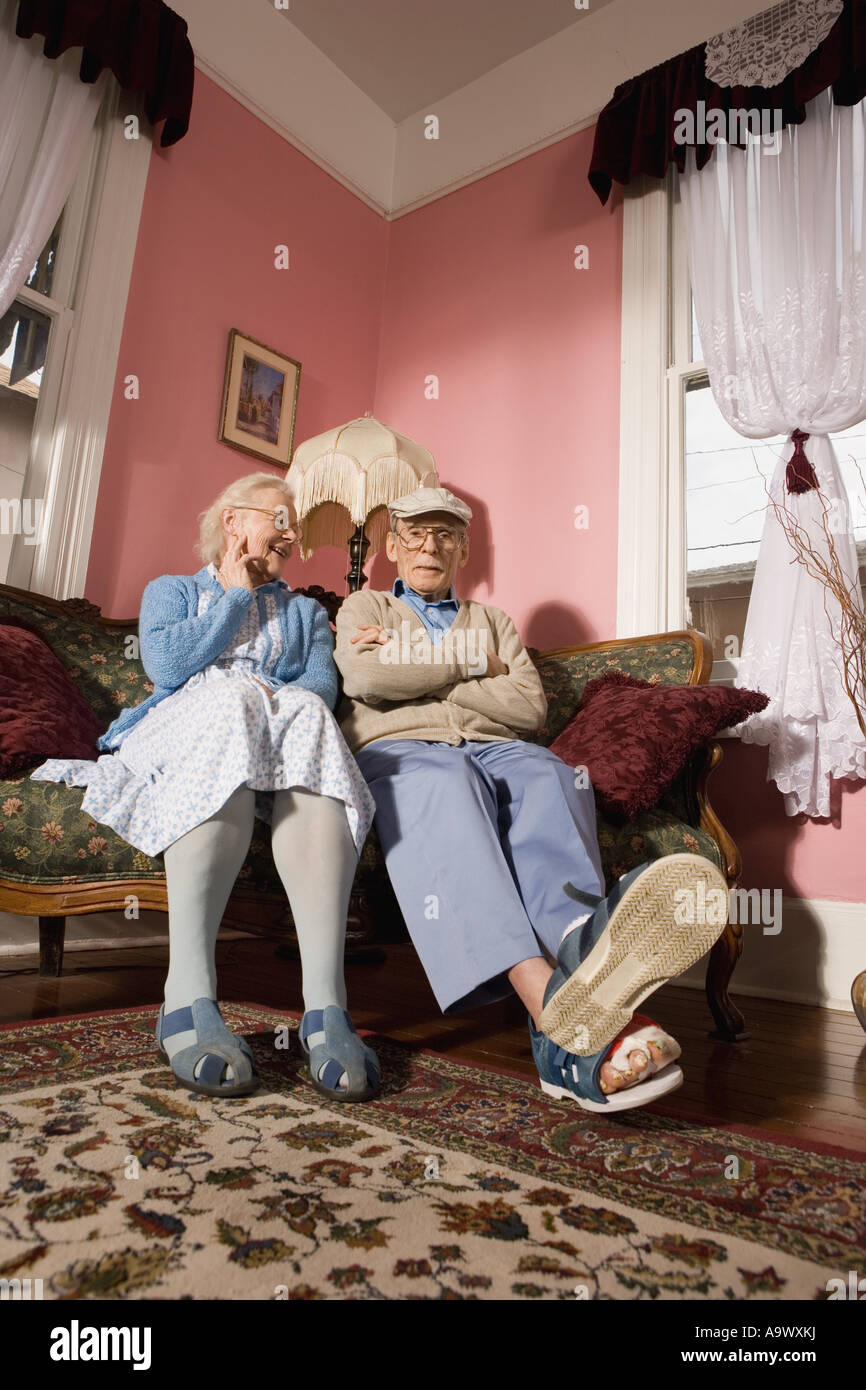 Old couple sitting on sofa hi-res stock photography and images - Alamy