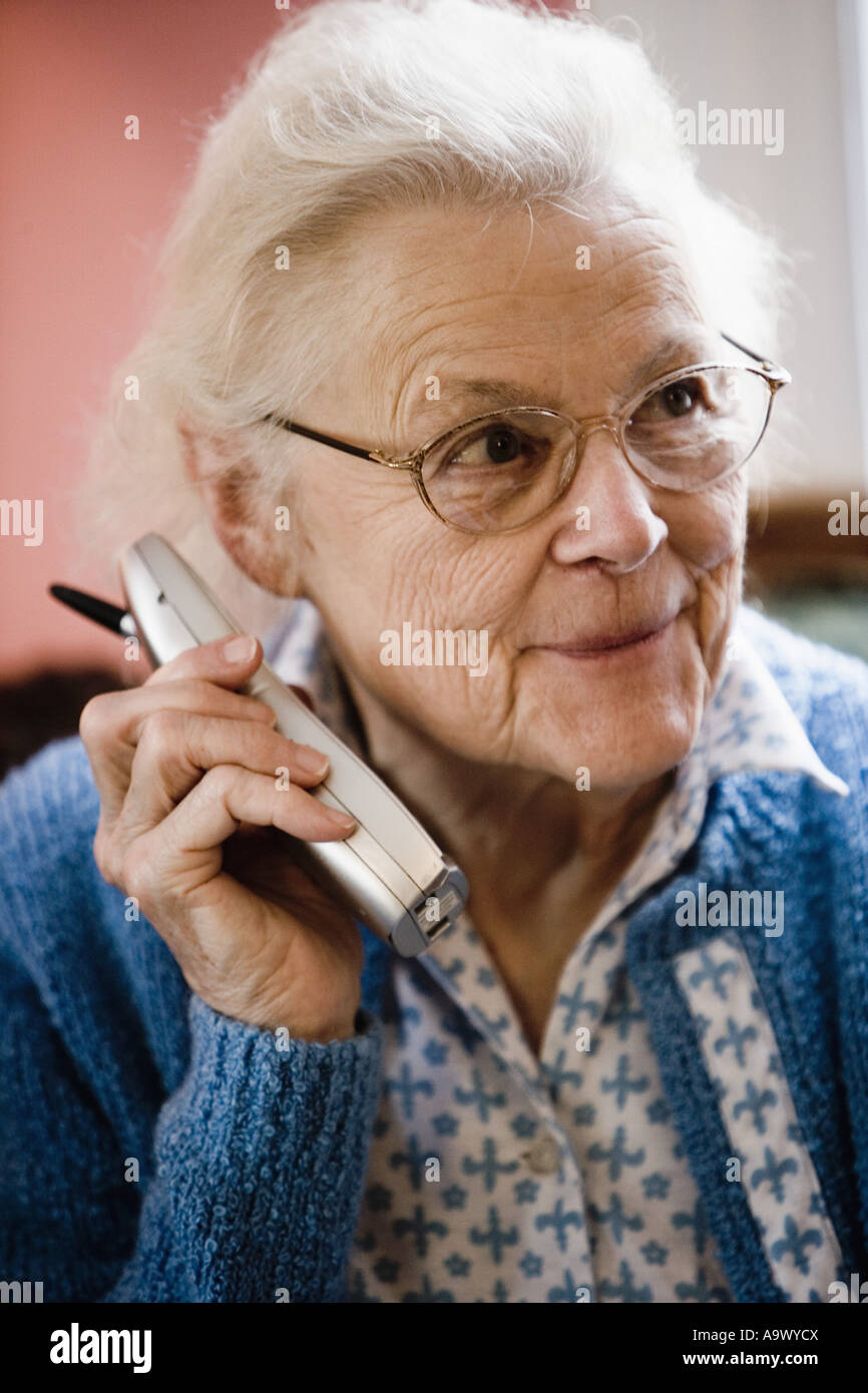 Smiling senior woman talking on cordless phone Stock Photo - Alamy