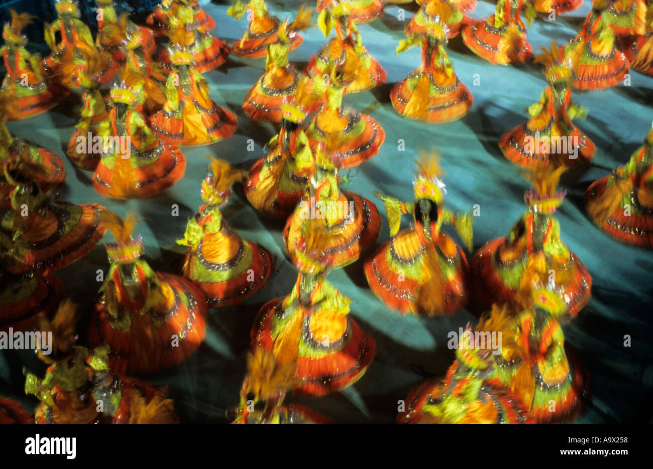 Rio de Janeiro, Brazil. Carnival; vibrant samba dancing baianas, in yellow and orange. Sapucai, sambodromo. Stock Photo