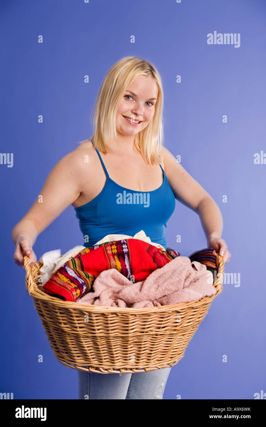 Smiling attractive blonde young woman with a basket of laundry Stock ...