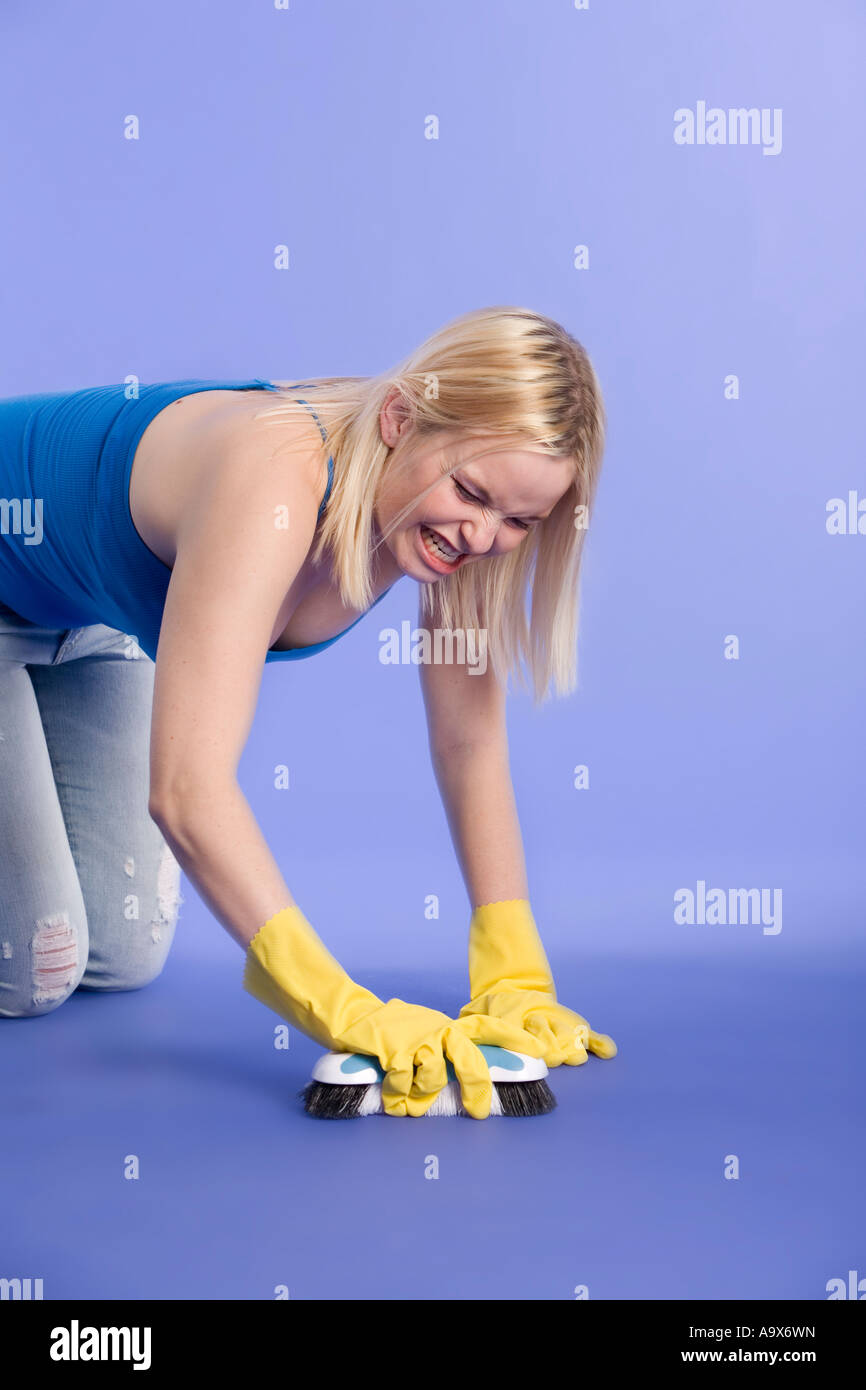 Blonde woman scrubbing a floor Stock Photo Alamy