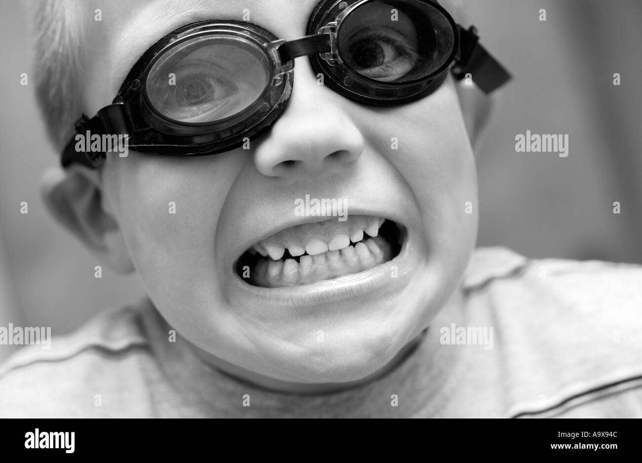 5 year old boy wearing goggles with mouth open Stock Photo