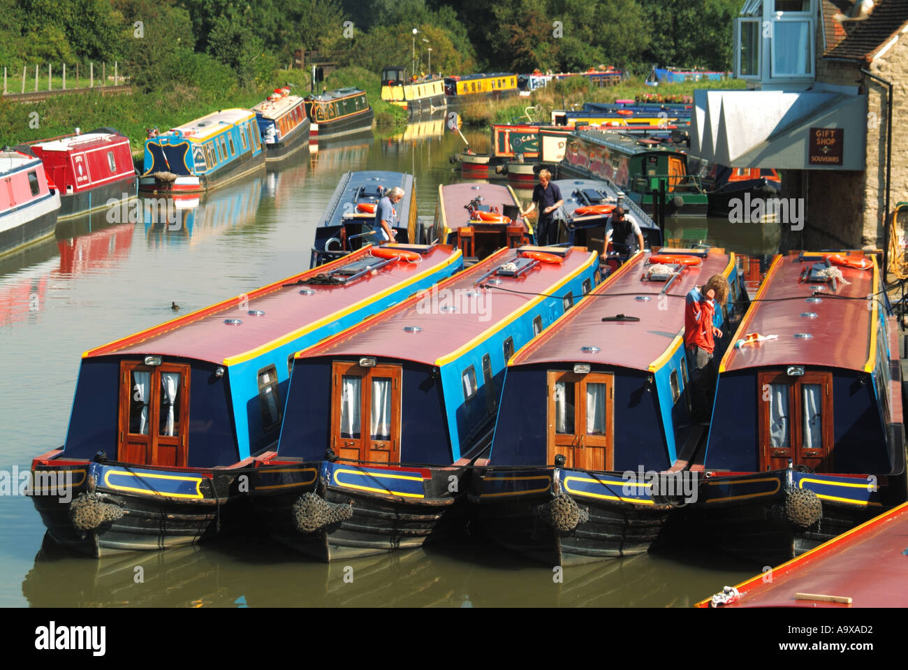 Aerial view workers in boat yard & narrowboat moorings on Oxford Canal narrow boat preparation for summer holiday hire season  Oxfordshire England UK Stock Photo