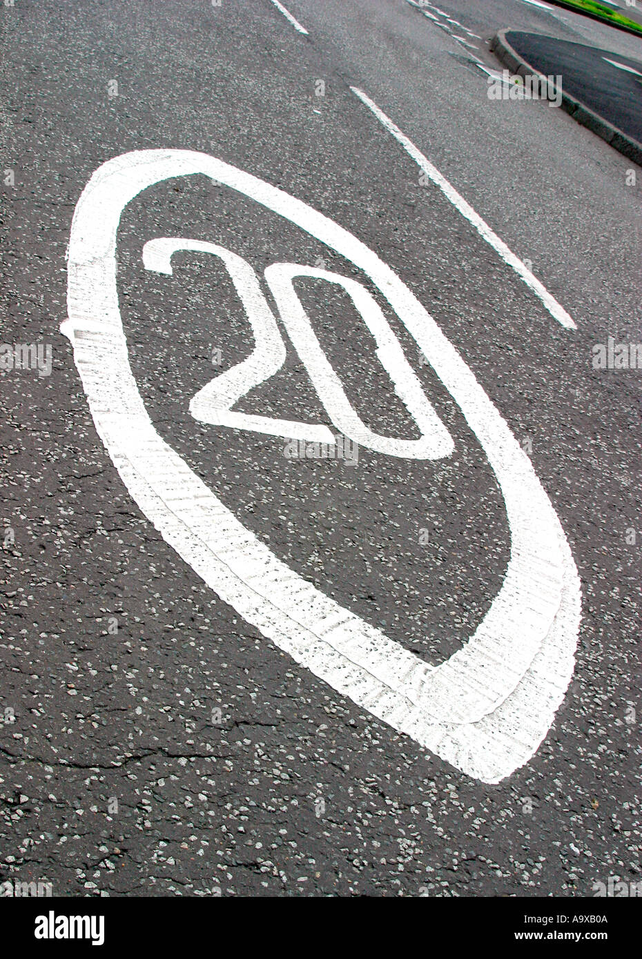 Twenty miles per hour speed limit sign painted on road Stock Photo