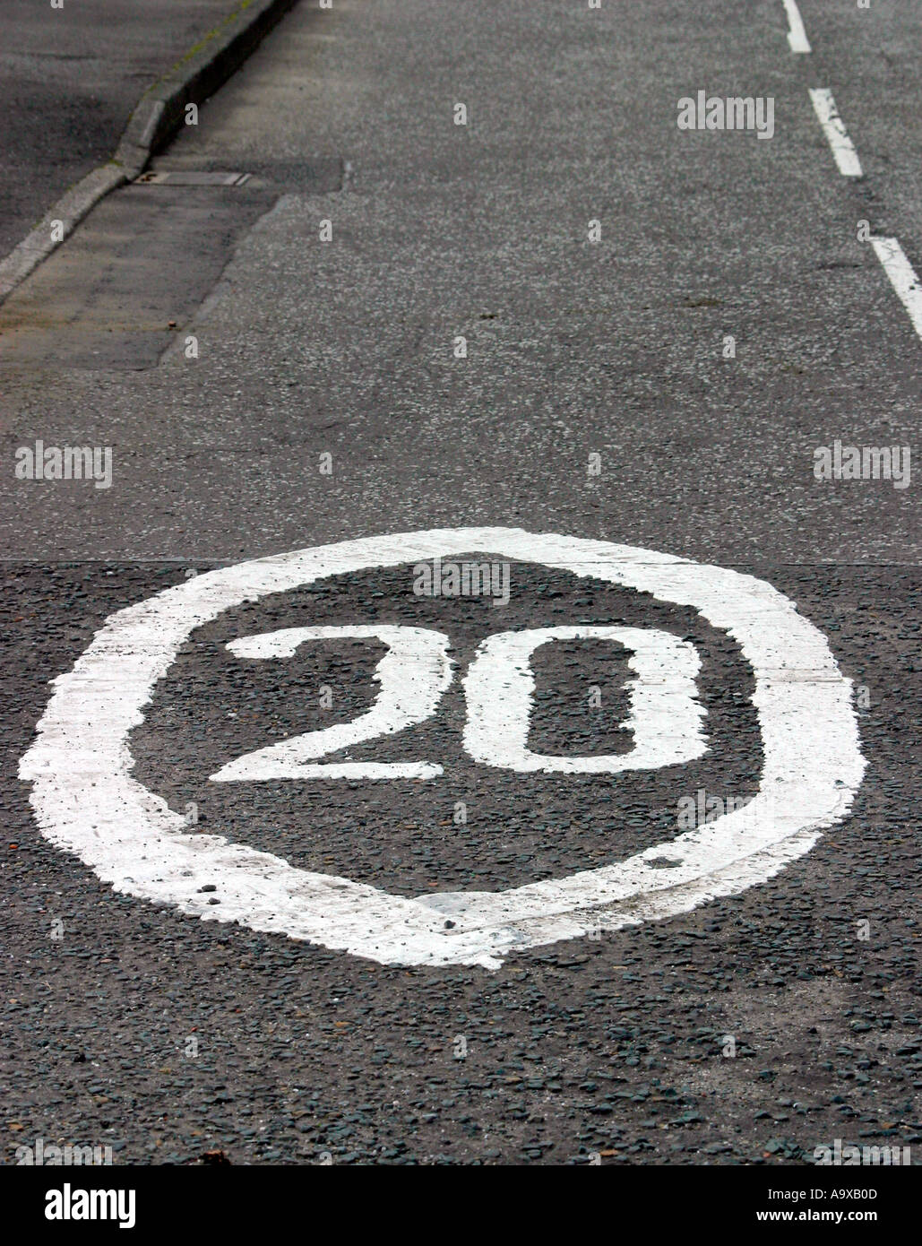 Twenty miles per hour speed limit sign painted on road Stock Photo