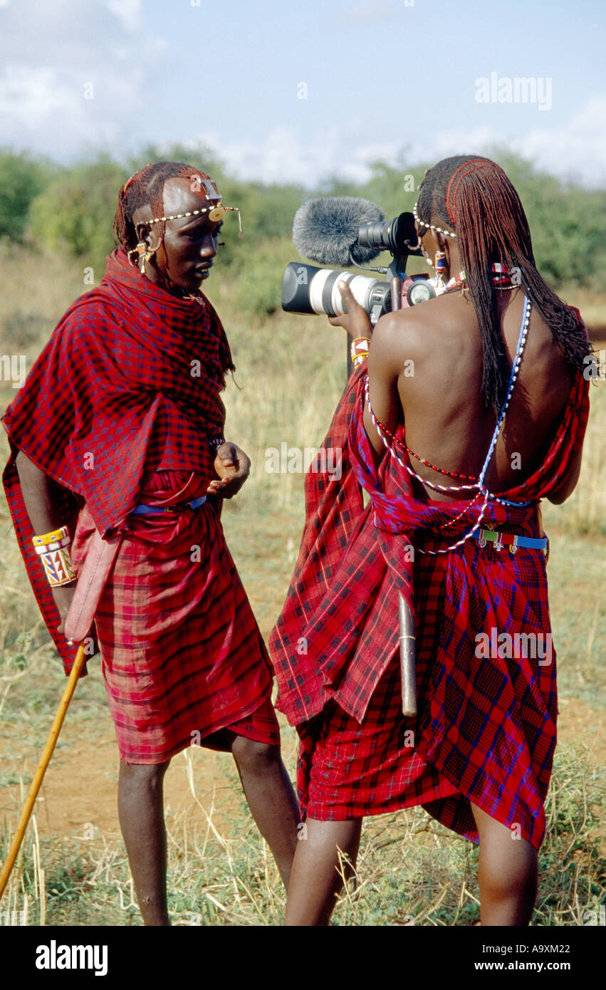 two Maasai with modern film camera, wearing traditional clothes, Kenya