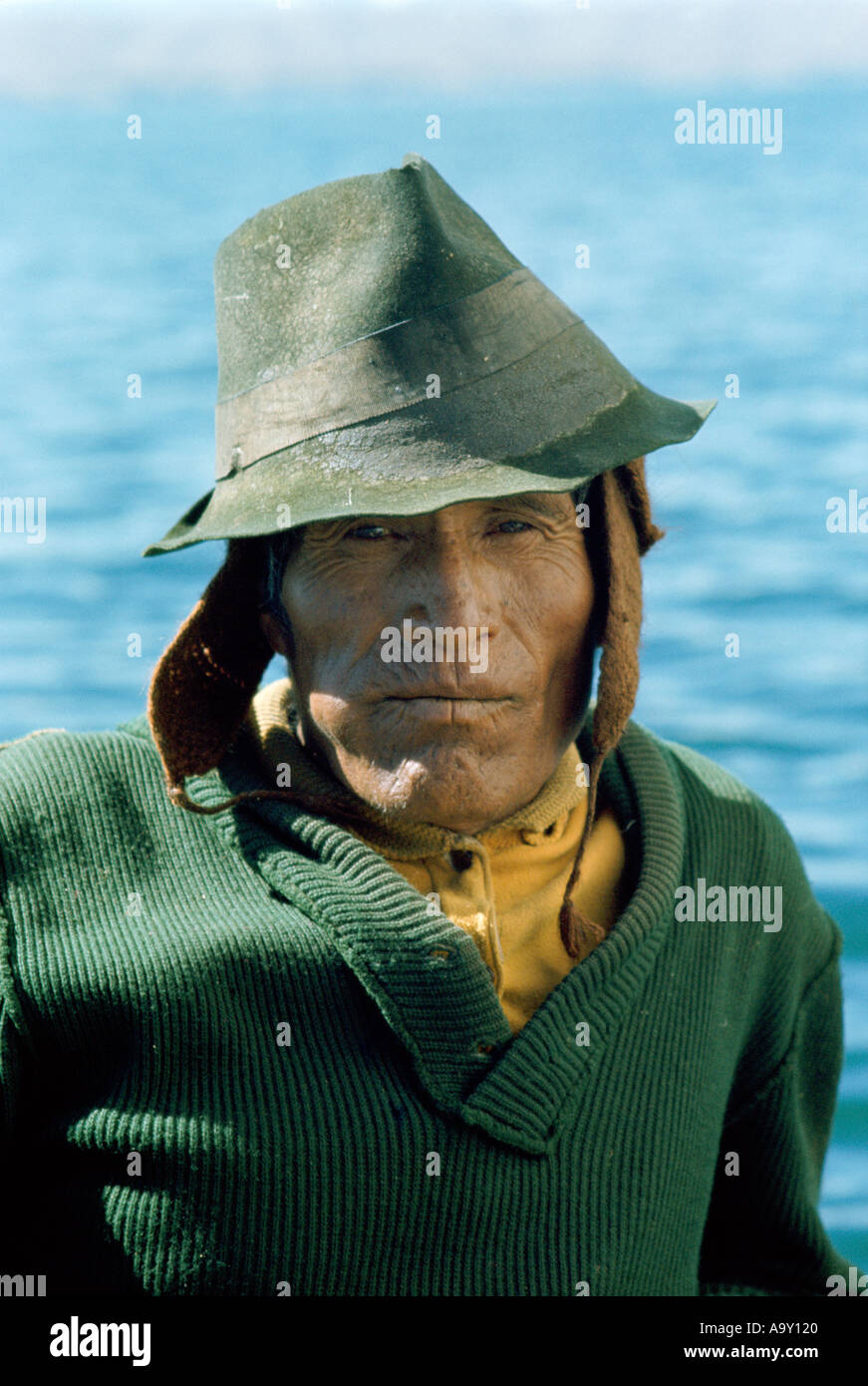 Aymara Indian fisherman chewing coca leaves swelling his cheek Lake Titicaca Bolivia Stock Photo