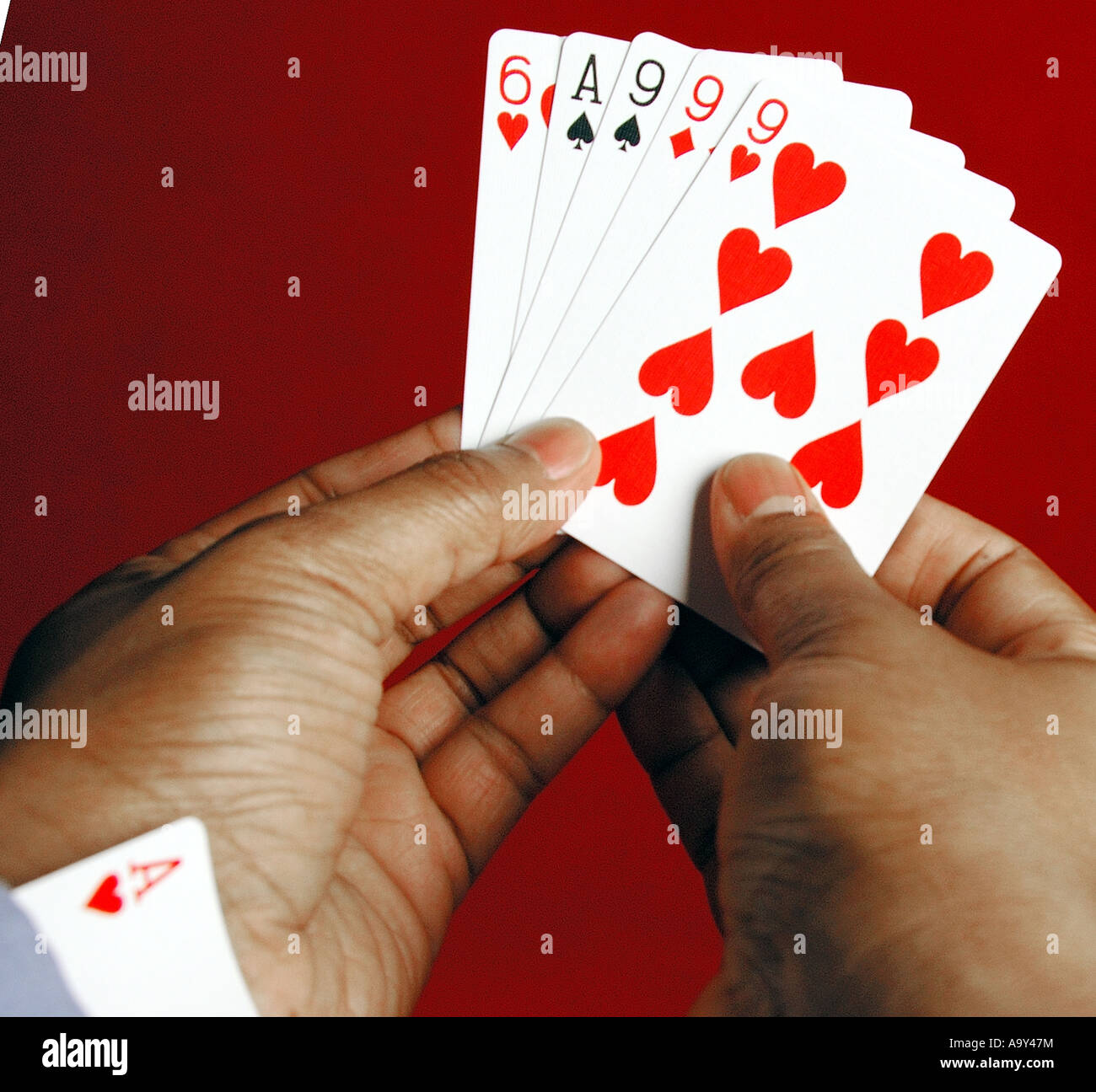 Poker hand with a possible full house with ace hidden up sleeve Stock Photo