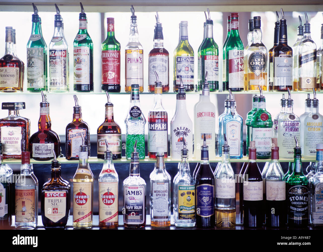 glass shelves full of alcohol spirit bottles Stock Photo