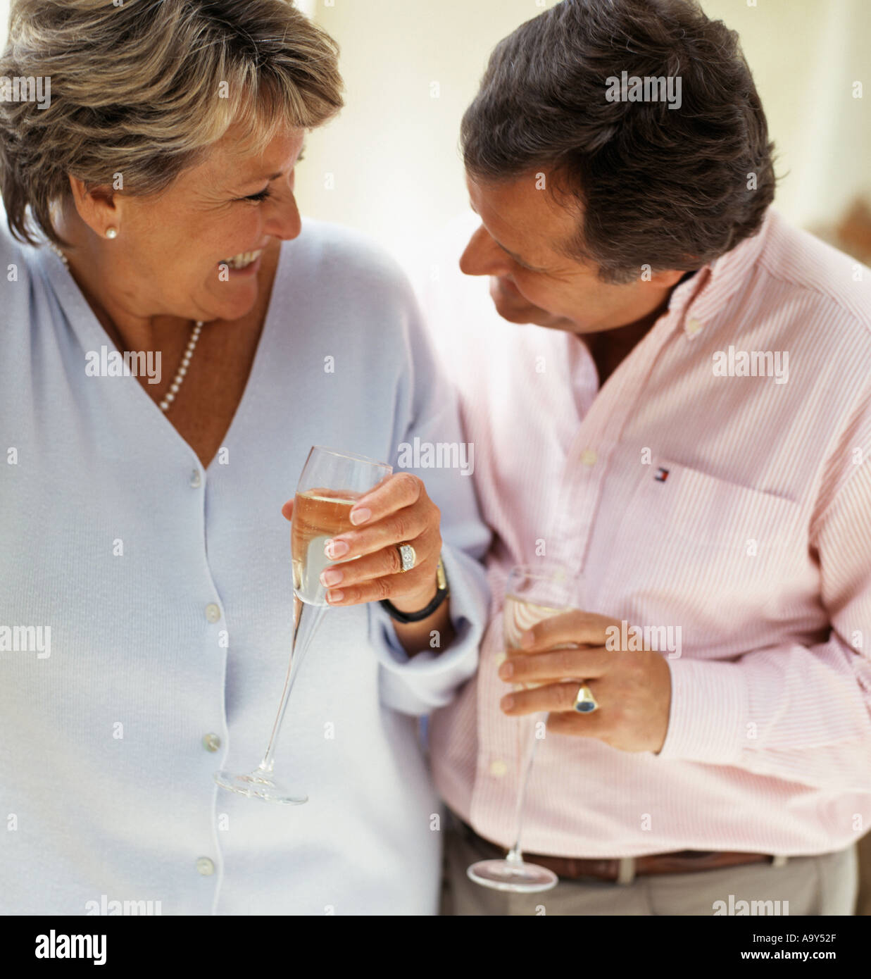 middle aged couple drinking wine laughing Stock Photo