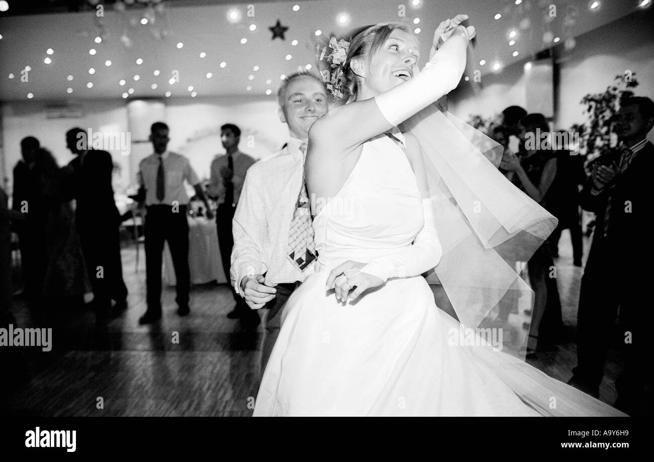 Poland, Lodz, bride dancing at wedding party, side view (B&W) Stock Photo