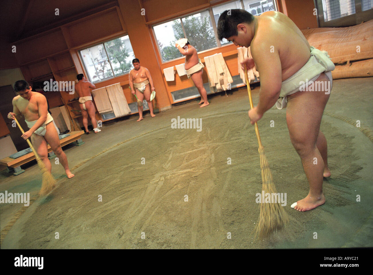Student sumo wrestlers prepare the Dojo in Japan Stock Photo