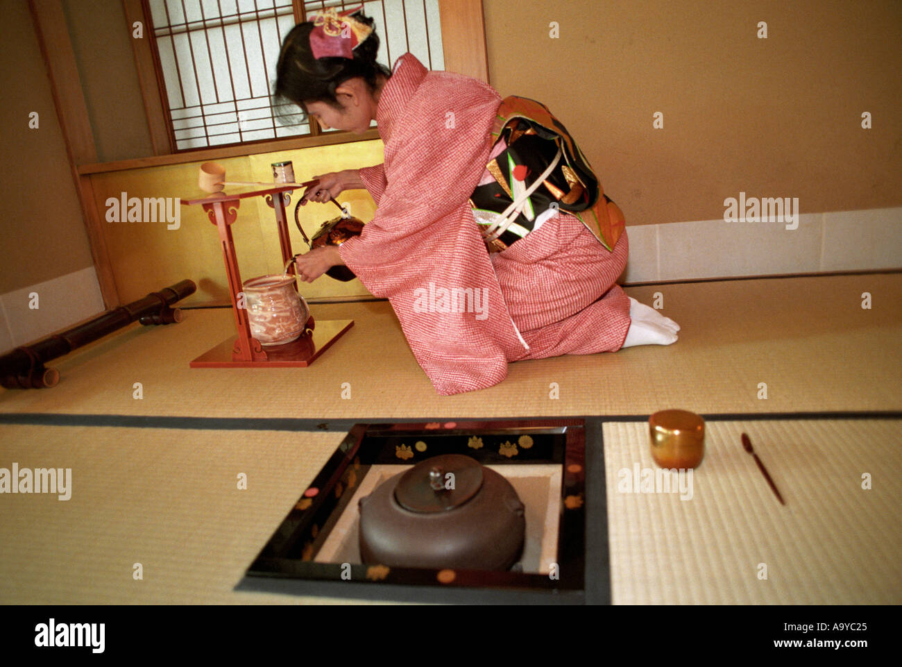 A lady in traditional Kimono preparing  tea at a Japanese tea ceremony in Japan Stock Photo