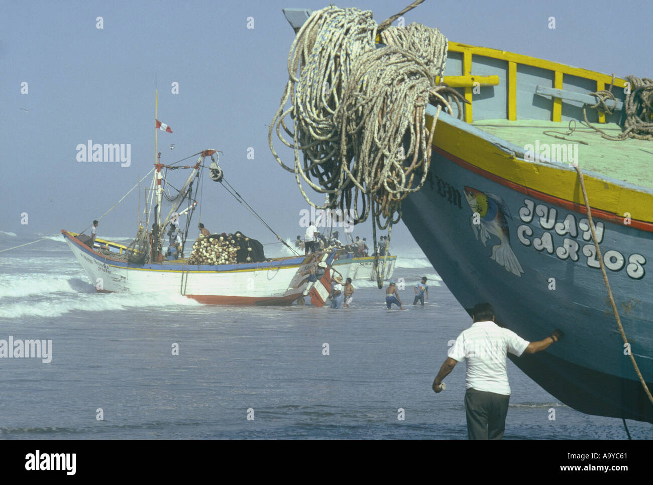 Launching a fishing boat (bolichero) into the surf at  Santa Rosa fishing village north  coast of Peru Stock Photo