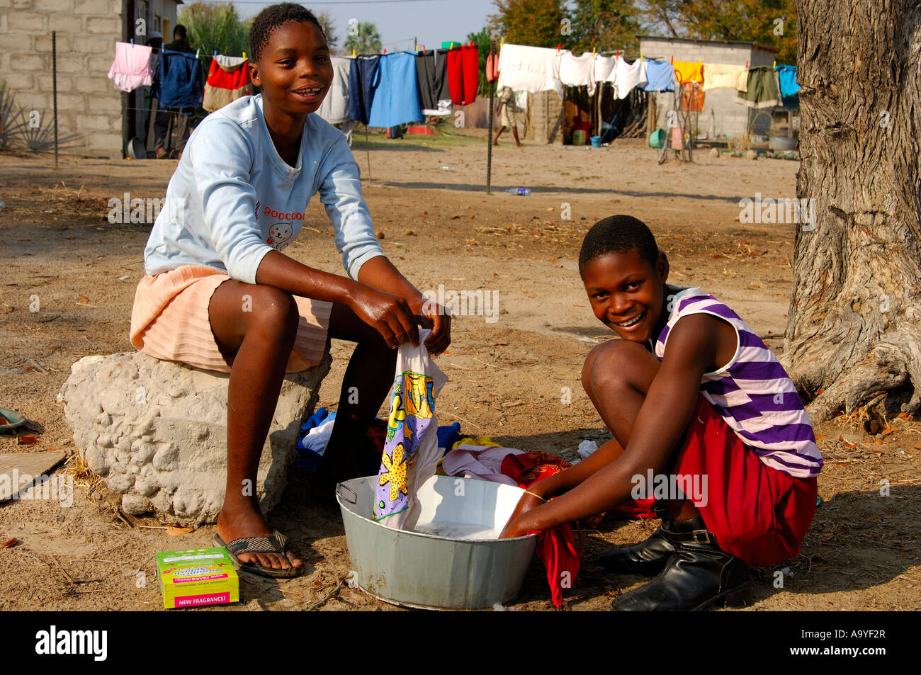 Young girls doing the laundry, Maun, Botswana Stock Photo