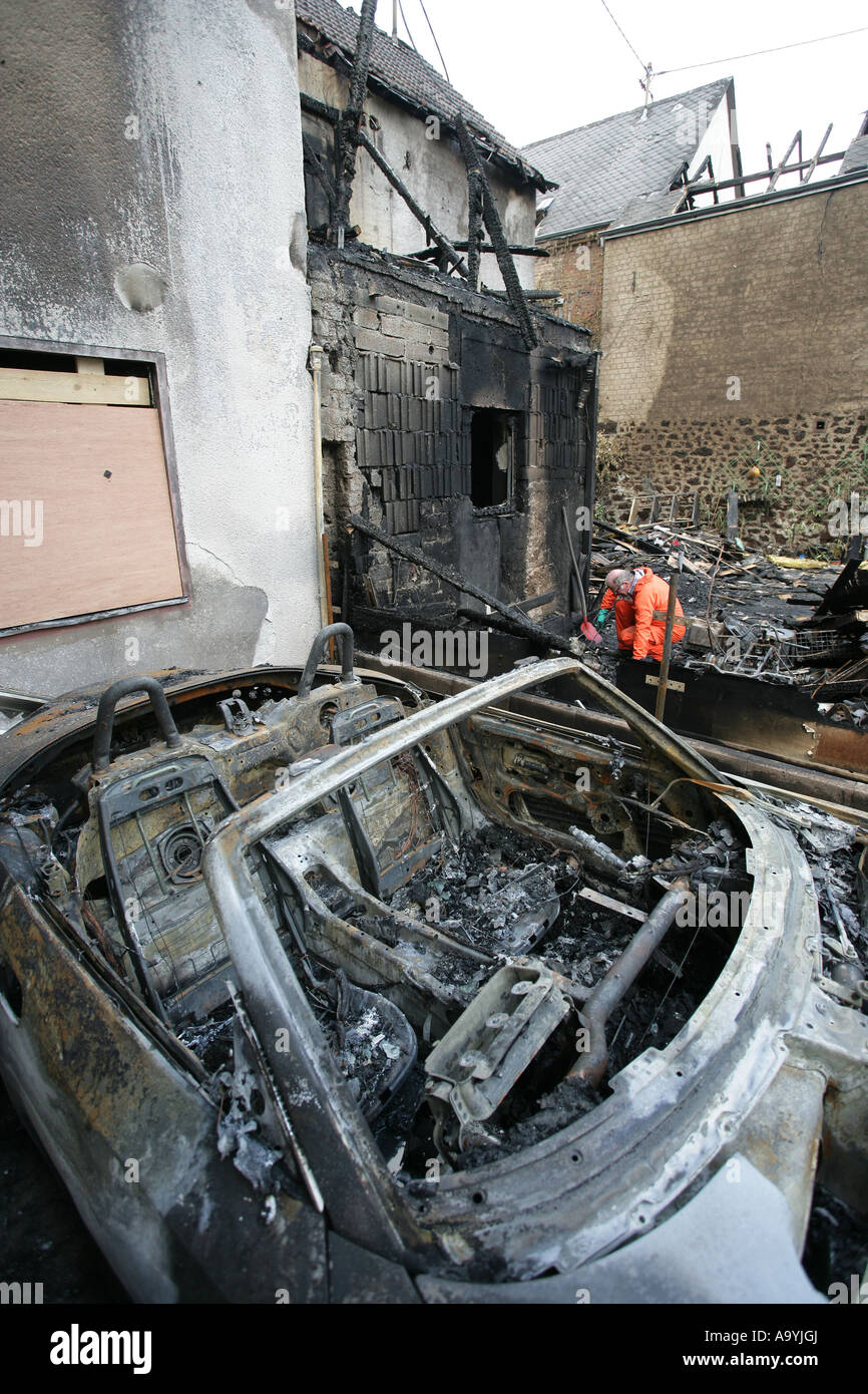 Destroyed Car and house after a fire , Koblenz, Rhineland-Palatinate, Germany Stock Photo