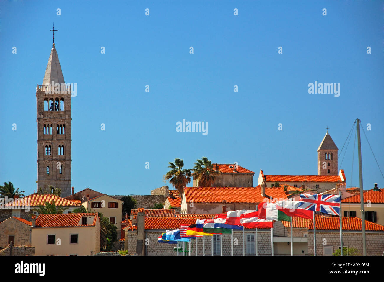 Flags in the village Rab with the Romanesque bell tower, Island Rab, Kvarner, Croatia Stock Photo