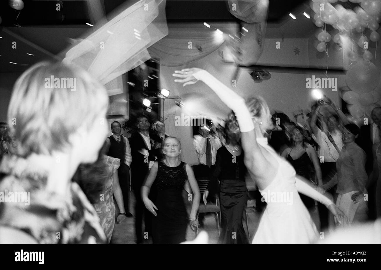 Poland, Lodz, bride throwing veil at wedding party (B&W) Stock Photo