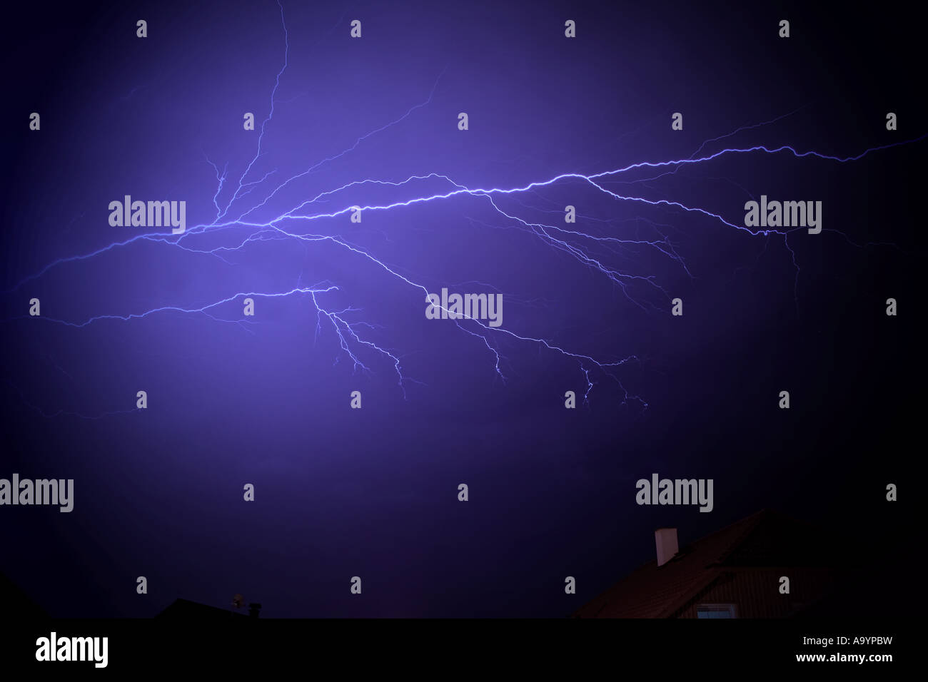 Dramatic lightning bolt illuminating a dark night sky during a ...