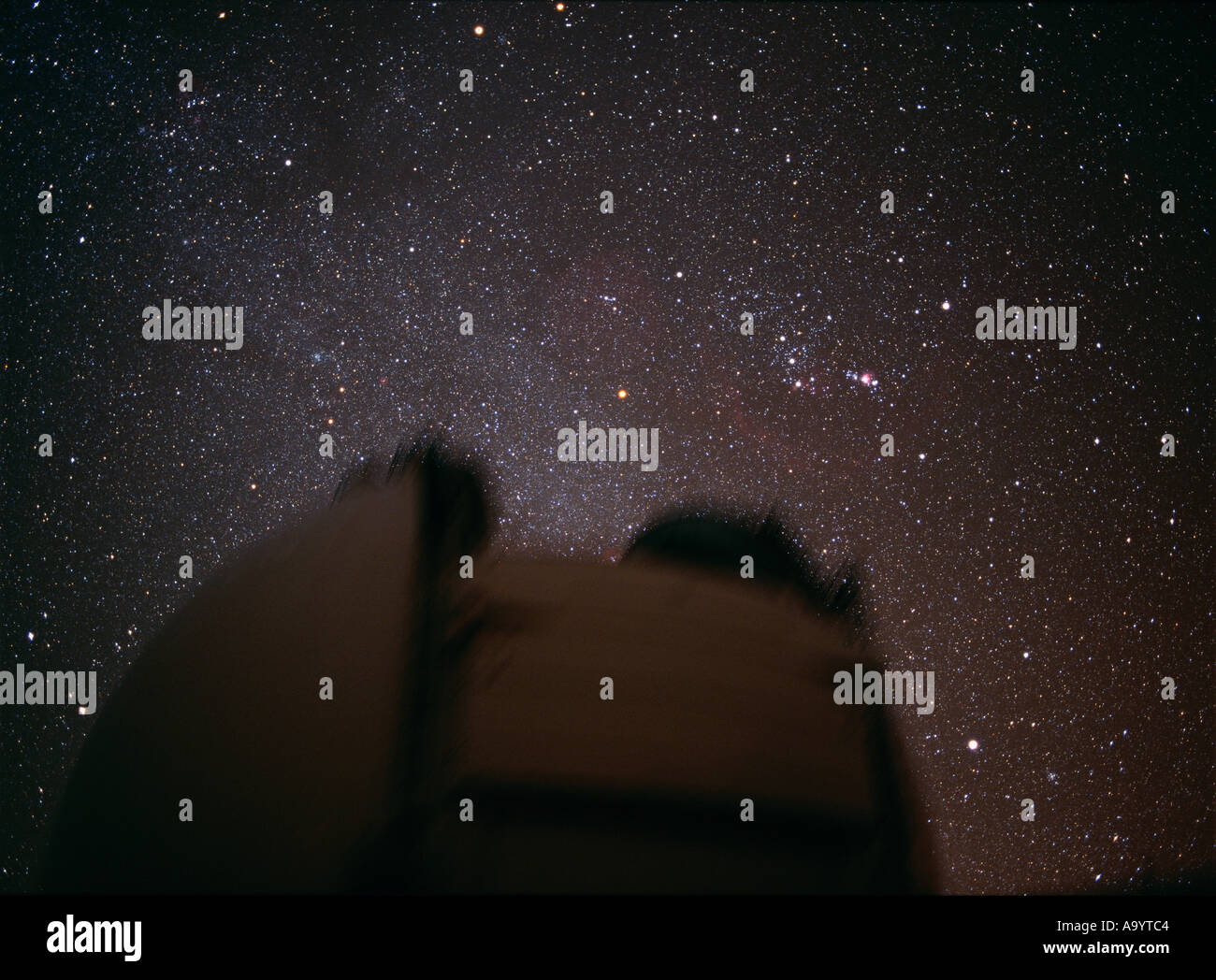Keck 2 telescope dome in the foreground with the constellation of Orion in the sky behind Mauna Kea Observatory Hawaii Stock Photo