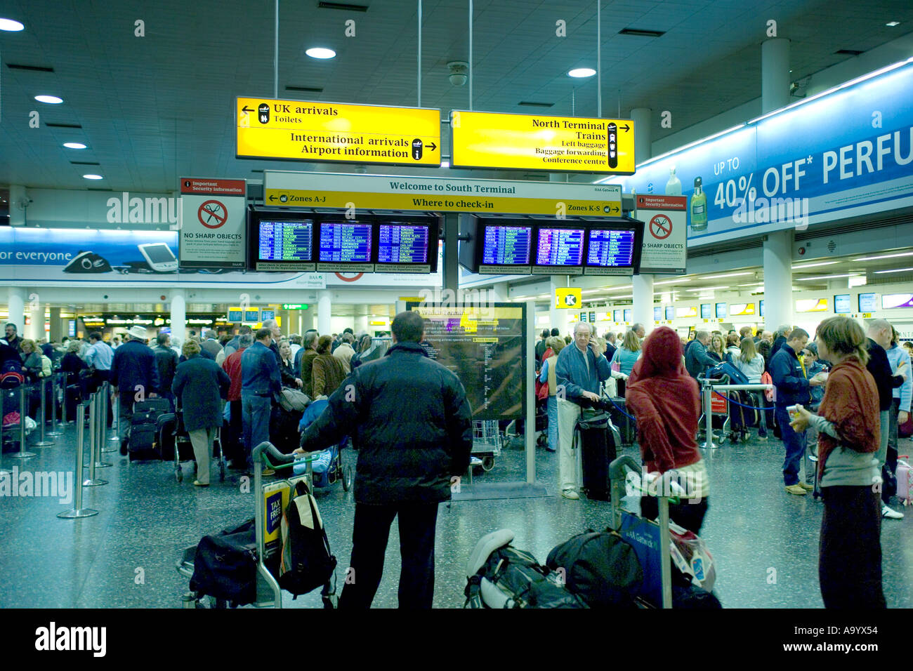 Reading departure screen at Gatwick Airport Departure Lounge Stock