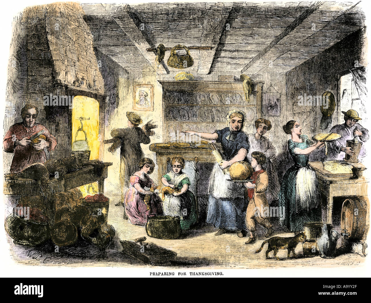 Family preparing Thanksgiving dinner 1850s. Hand-colored woodcut Stock Photo