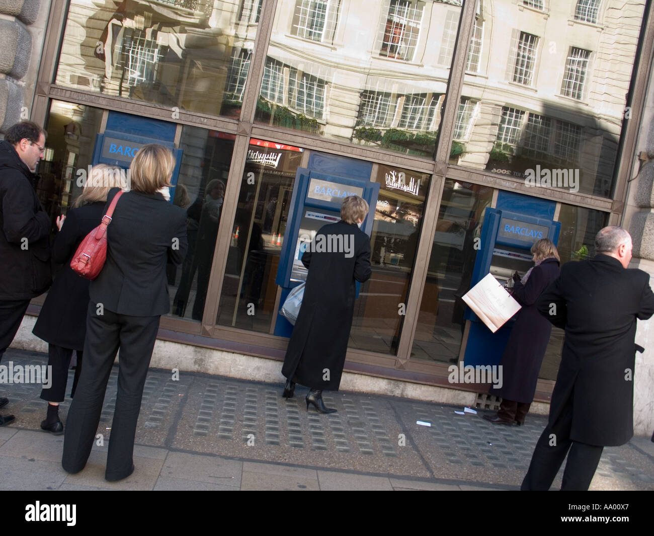 People withdraw cash from ATM Stock Photo