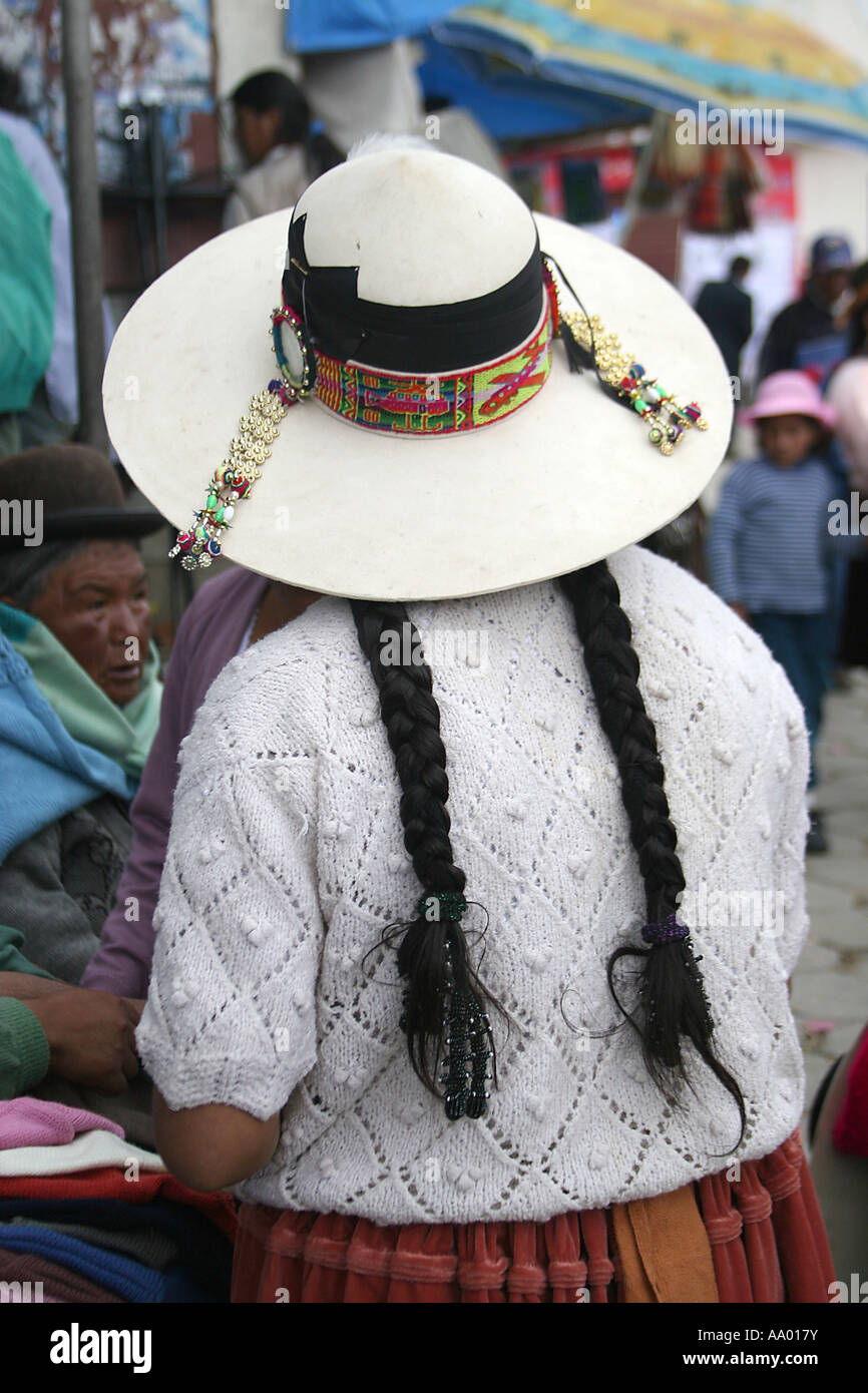 Traditional Bolivian Woman with long hair wearing a white hat in