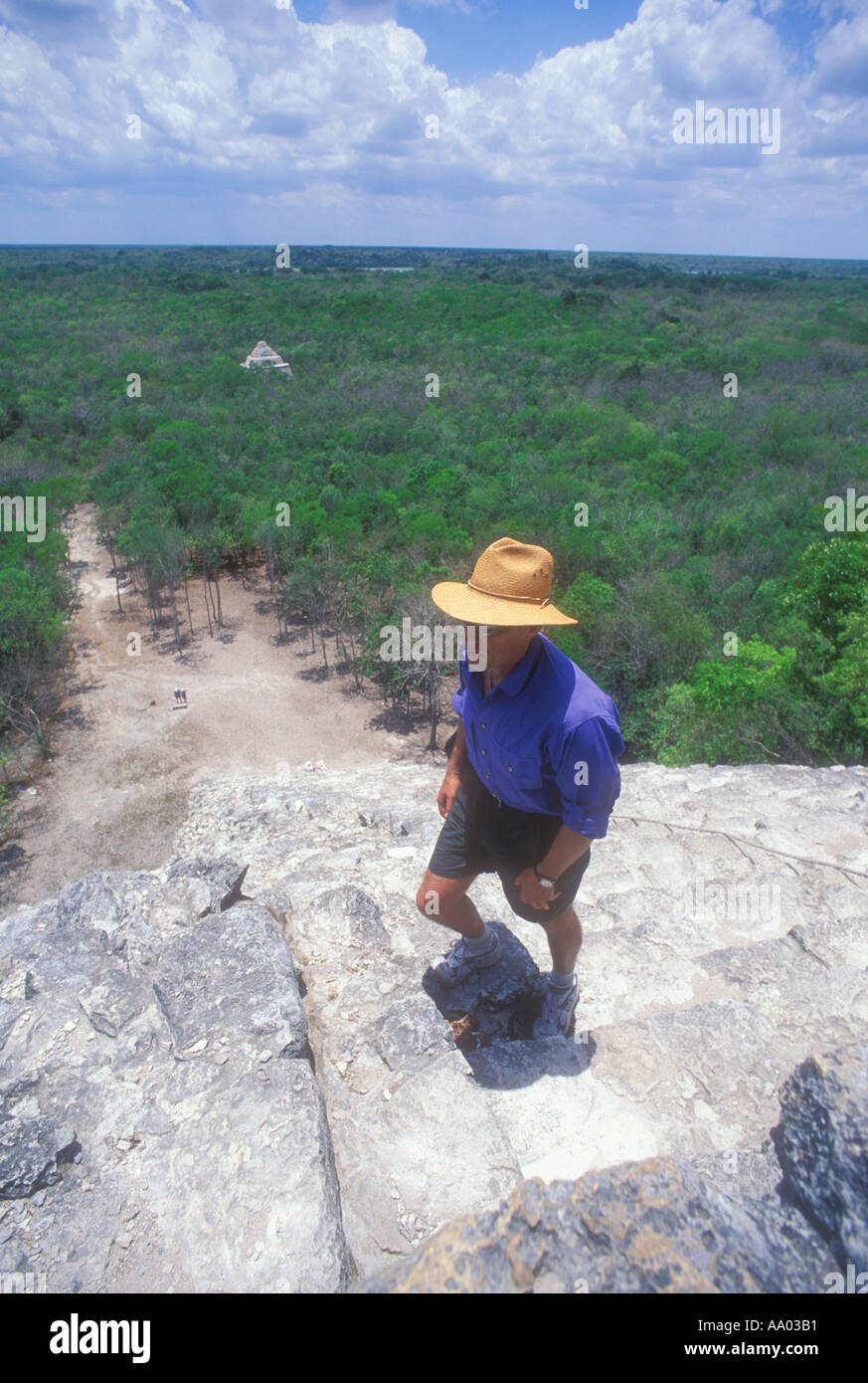 Man climbing Mayan pyramid at the ruins at Coba in the Yucatan Mexico