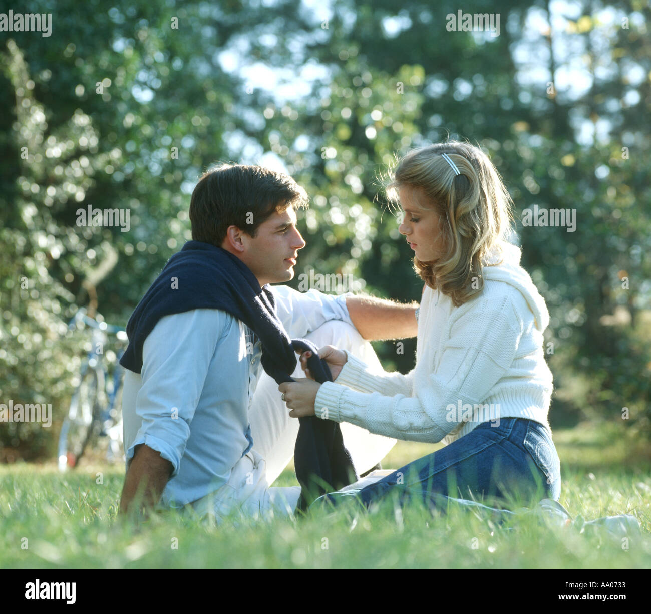 romantic young couple chatting in park Stock Photo