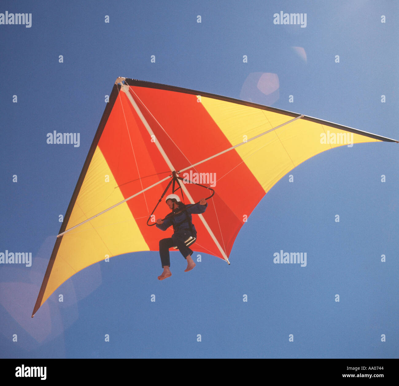 man flying hang glider over lake after being released by a tow boat