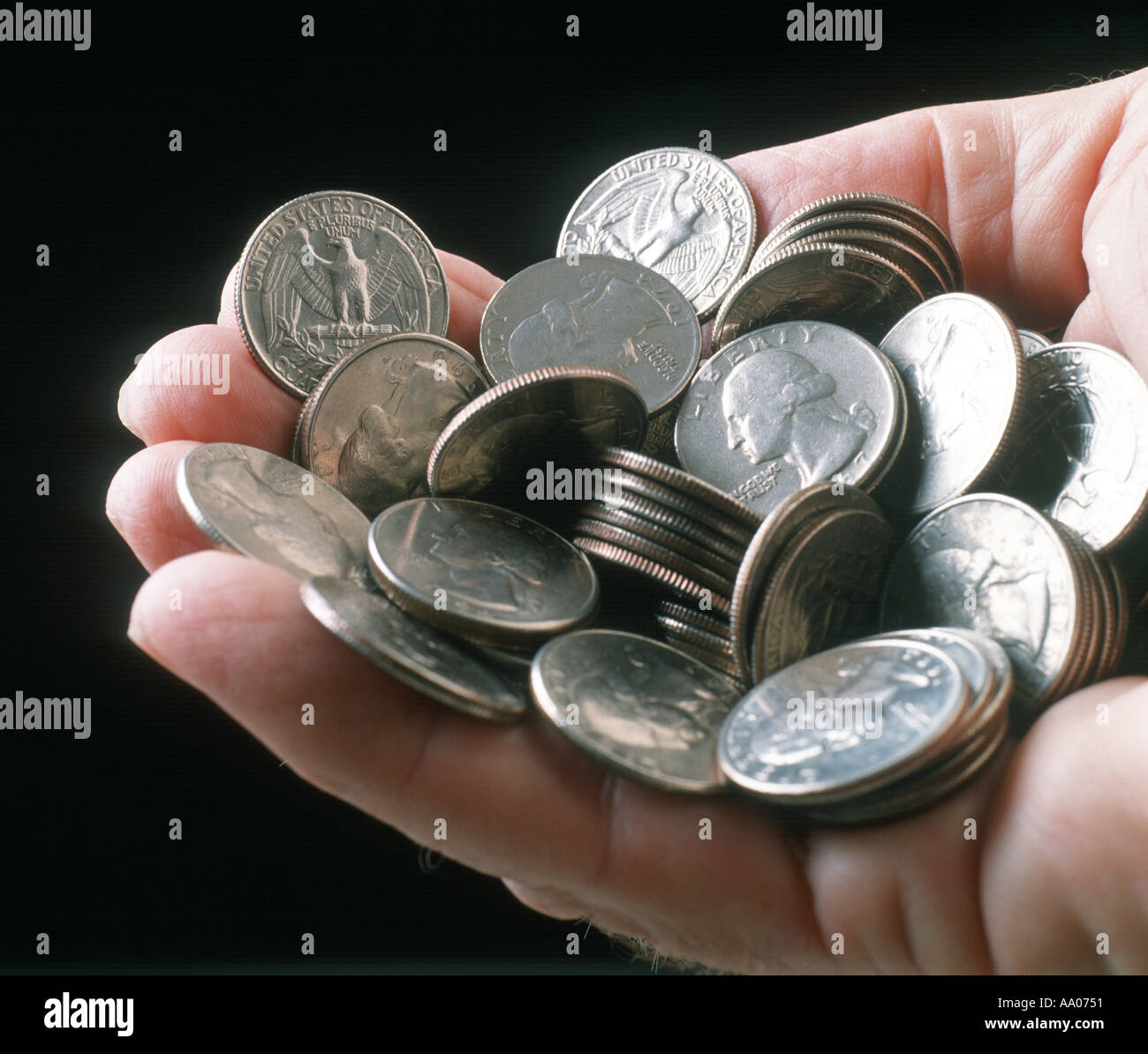 money male hand full of 25 cent coins quarters US Stock Photo