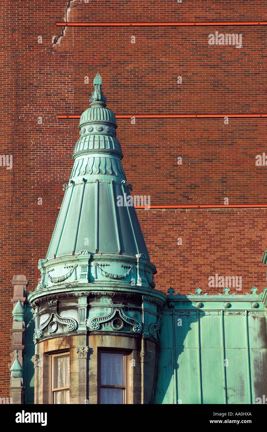 A fine old french style house contrasts with the ugly red brick