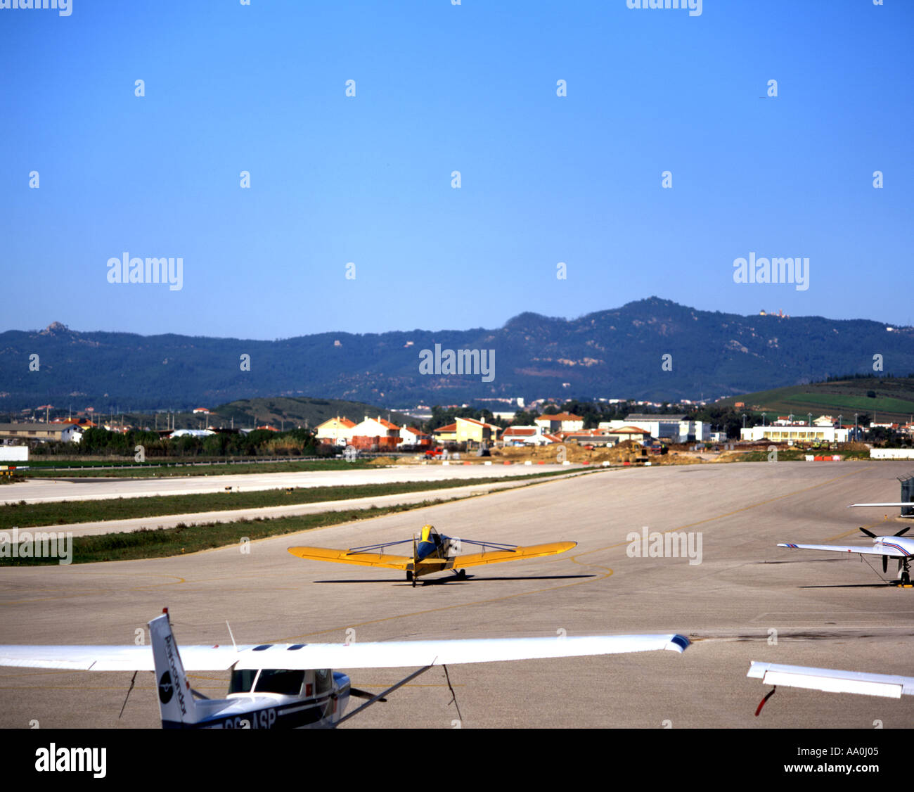 PORTUGAL Tires village Estremadura Province Tires airport light plains on runway mountain beyond houses Stock Photo