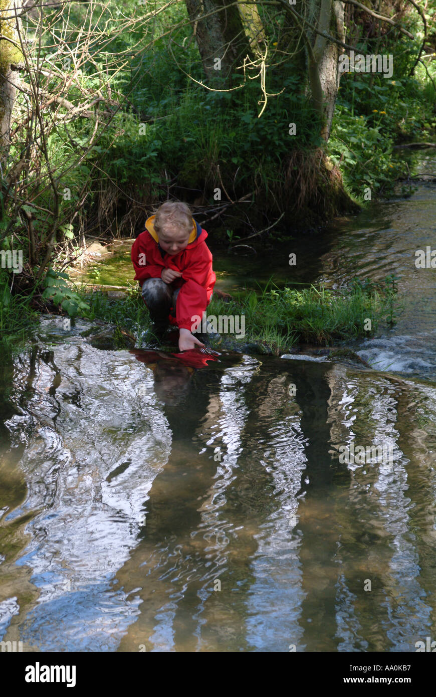 Little boy on a riverbank Stock Photo - Alamy