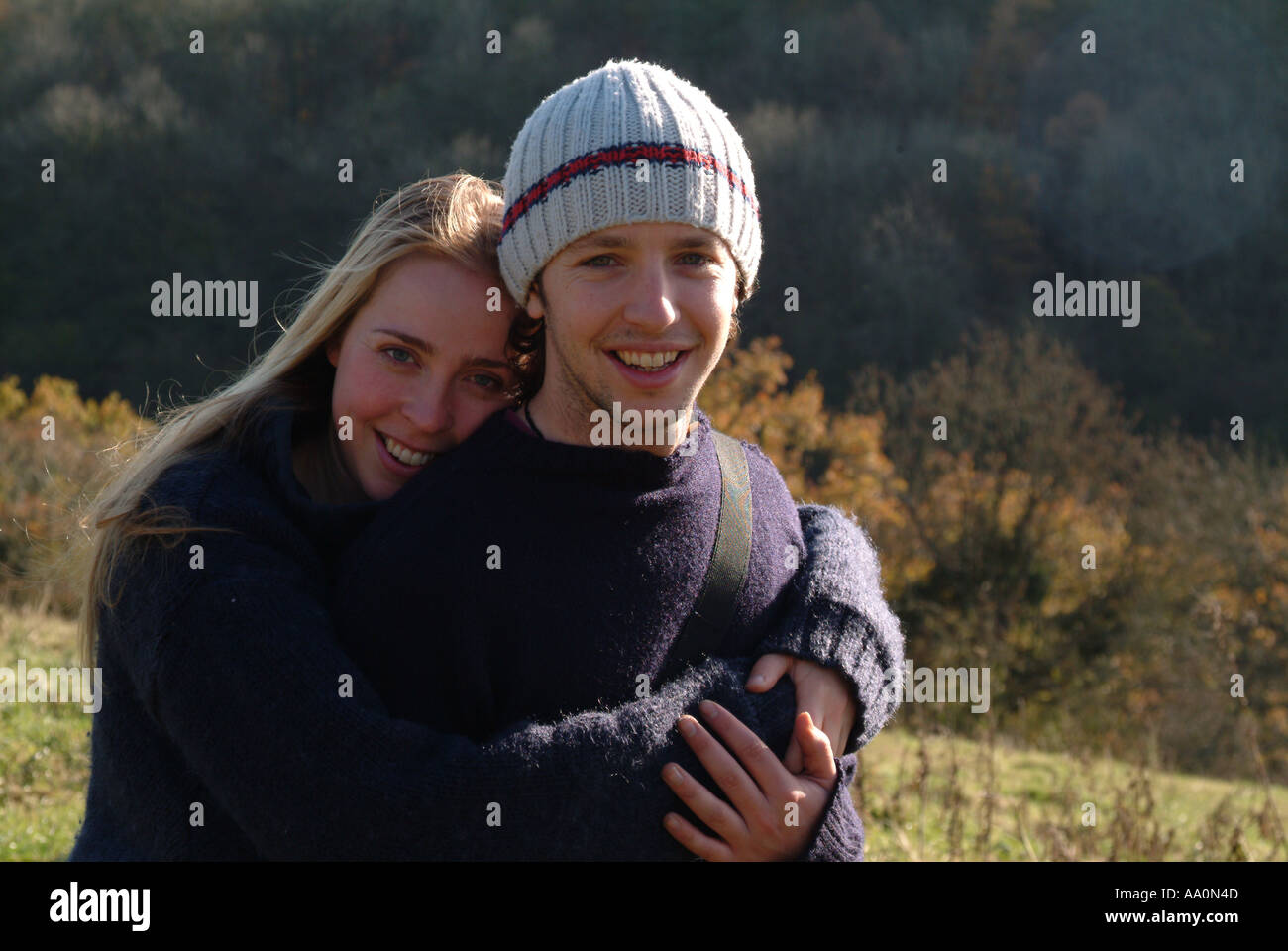 Portrait of a young couple with their arms around each other Stock ...