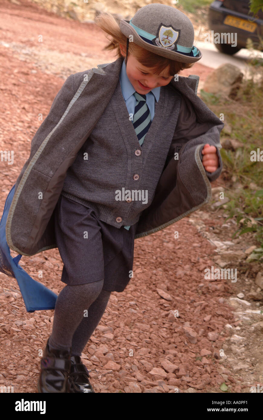 Girl wearing school uniform, running and excited Stock Photo Alamy