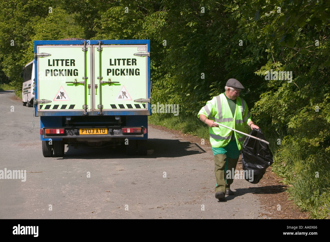 a highways dept litter picker cleaning litter from the roadside Stock