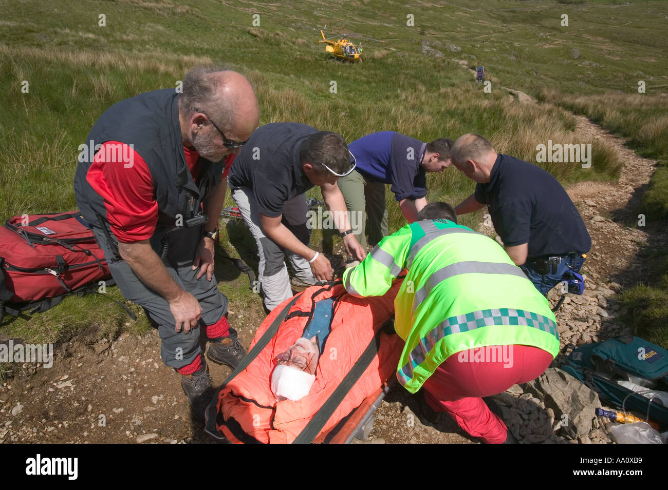 Air ambulance paramedic and mountain rescue team treat a casualty Stock
