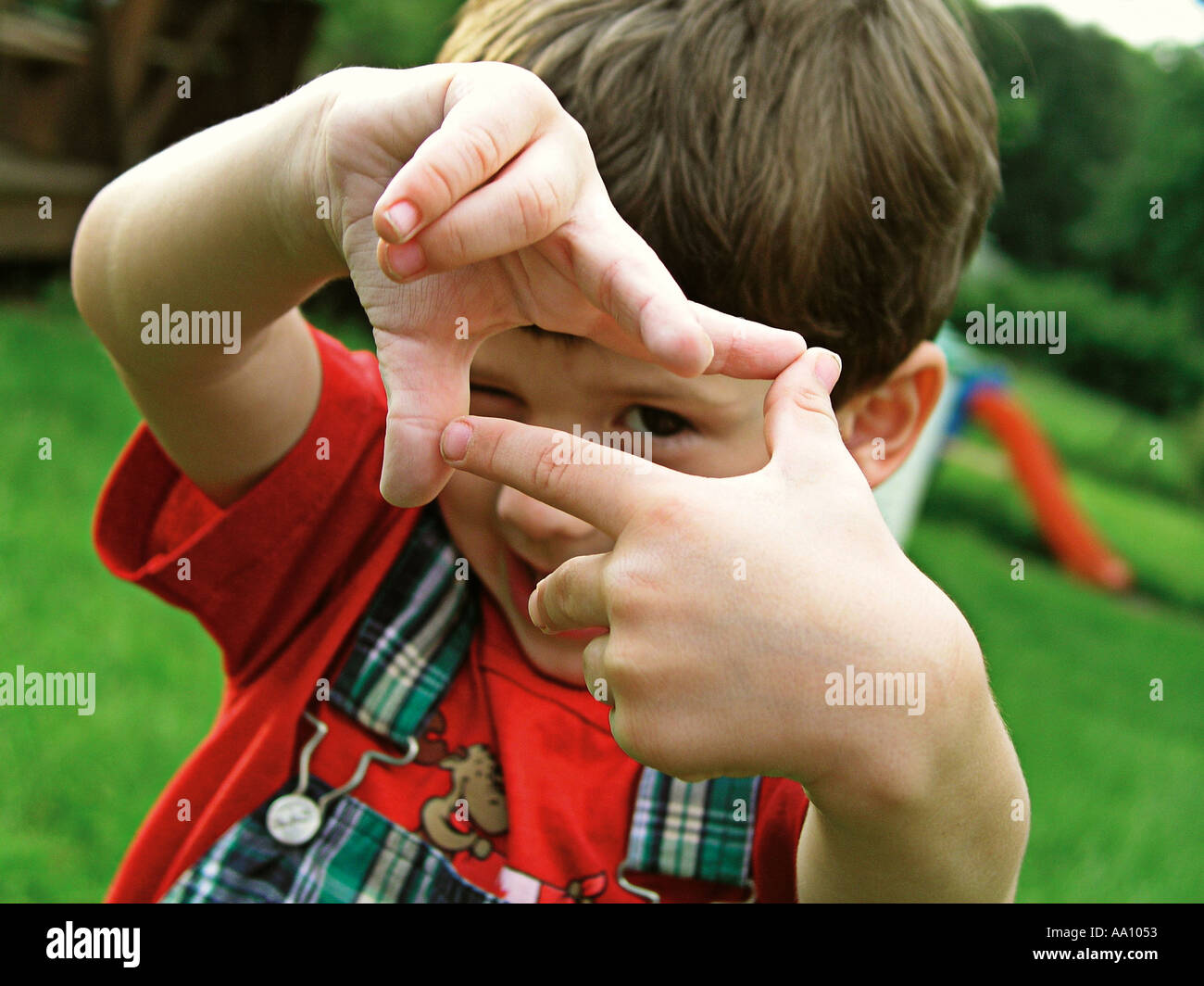 BOY FRAMING EYES while smiling Photographed in PA Stock Photo Alamy