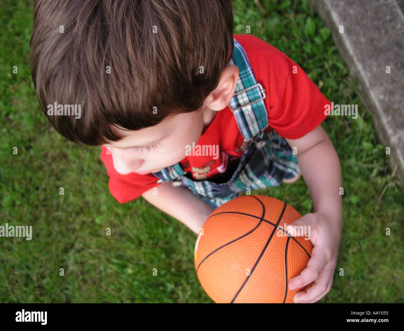 BOY WITH BASKETBALL in motion on the grass Photographed in Pennsylvania Stock Photo