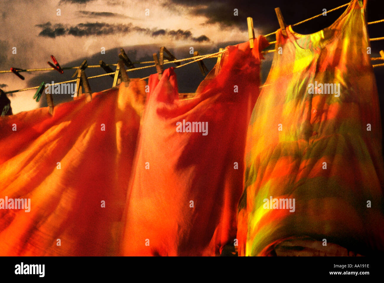 Colorful dresses hanging on clothesline and blowing in the wind against