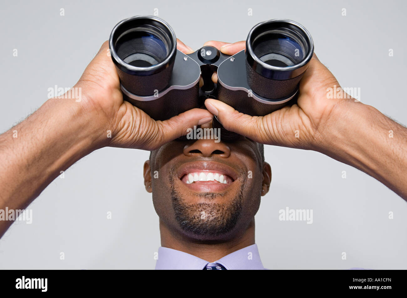 Man looking through binoculars Stock Photo Alamy