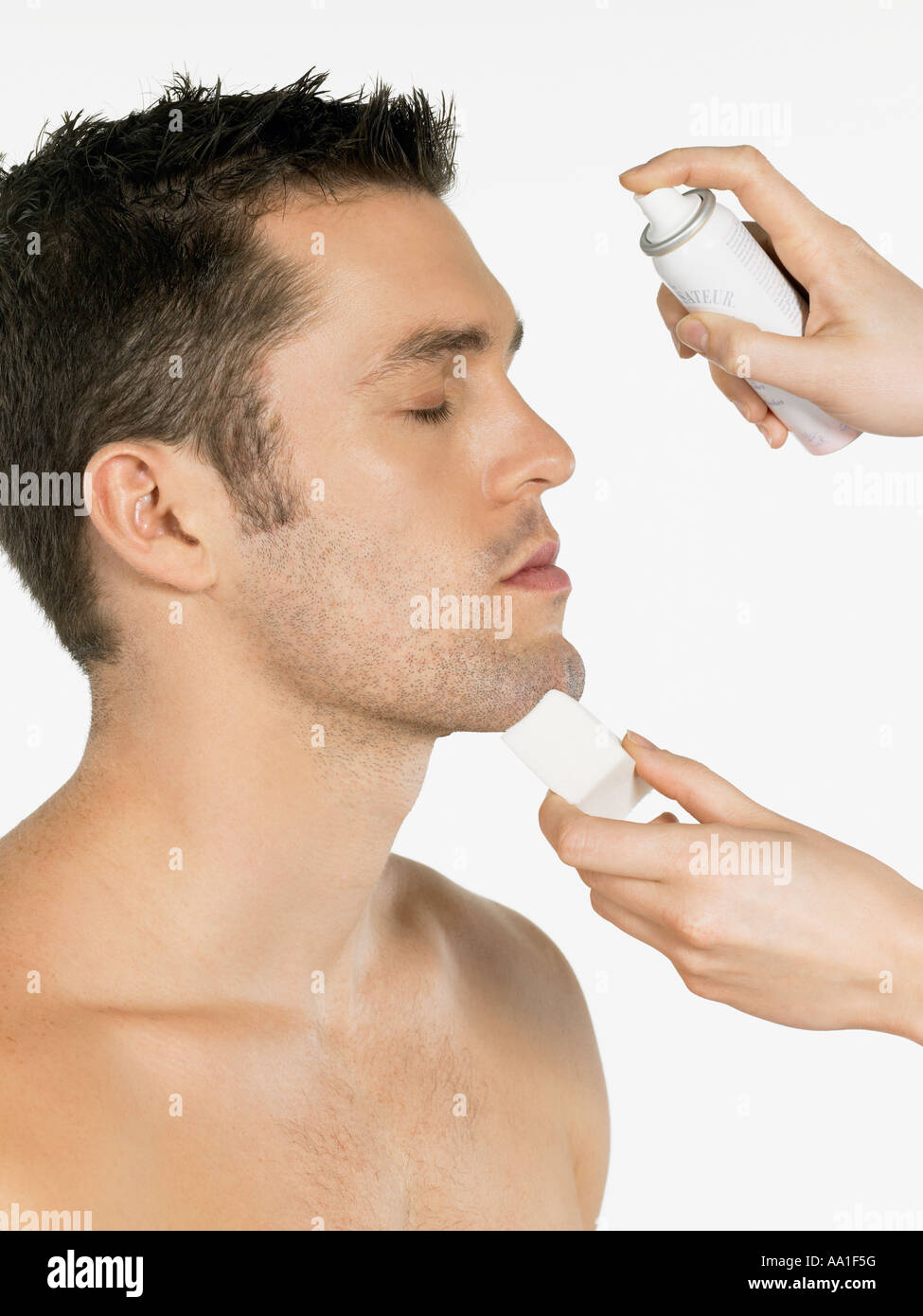 Man having water sprayed on his face Stock Photo