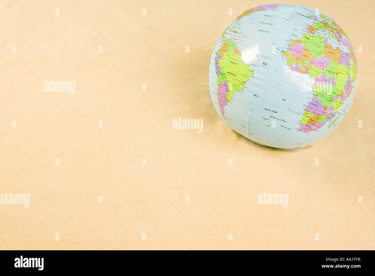 Inflatable globe on beach Stock Photo